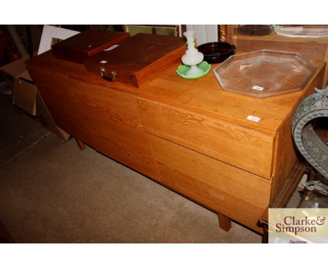 A light oak sideboard fitted double cupboards and three drawers 