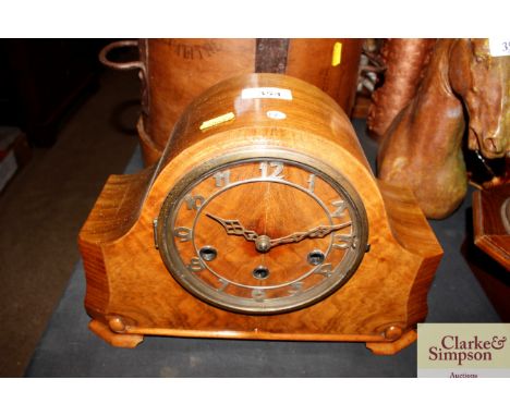 A 1920's figured walnut three hole mantel clock with pendulum, winder and repeat mechanism 