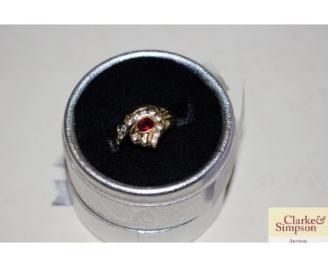 A 585 marked yellow metal ring set red and white stones, 5gms