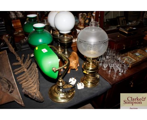 A brass and green glass desk lamp; and an oil lamp with opaque glass shade