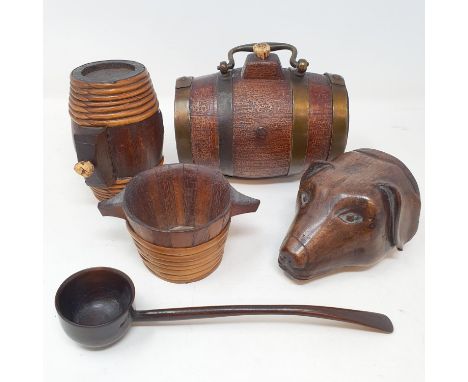 A late Victorian treen stirrup cup, in the form of a dog's head, ears chipped and some loss to the rim, 10 cm high, two costr