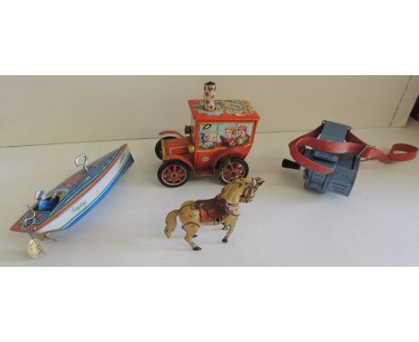 A West German made clockwork horse, with key 8.5cms high; a Lone Star diecast bus conductors ticket machine; a clockwork tinp