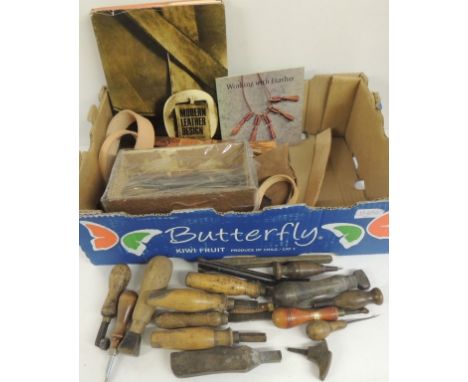 A quantity of leather working tools and some metal working tools, some small pieces of leather and roll of copper and two lea
