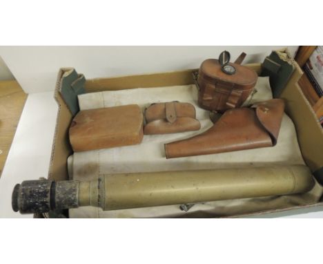 A white canvas kit bag; brown leather pistol holster; brown leather binocular case with compass set into the cover; other lea