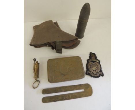 A WWI Princess Mary Christmas tin (no contents); a brass cigarette lighter; a brass polisher protector; a bullion Marine clot