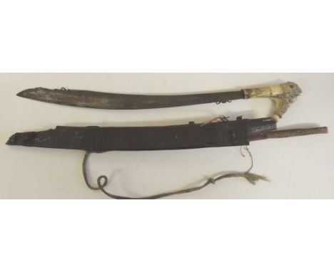 A 19th Century Dayak Mandau having carved horn hilt, the blade of traditional shape and with decoration to both sides, in sim