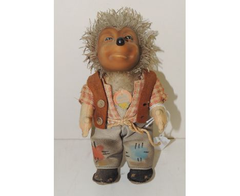 A Steiff Mecki figure, with moulded rubber face and original clothing, 18cms high