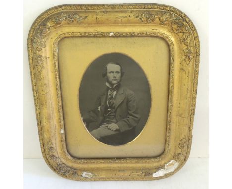 A rare whole plate ambrotype portrait of a young gentleman, seated , with gold highlighted watch chain, in original gilt gess