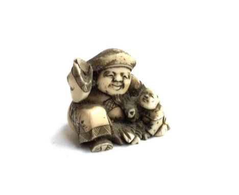 A small Meiji era Japanese ivory netsuke depicting a man and two infants (af), 4cmH 