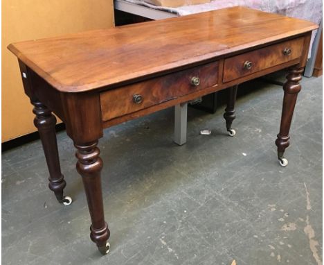 A Victorian mahogany side table/desk, with two drawers on turned legs and ceramic casters, 122x50x75cmH 