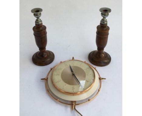 A pair of turned oak candlesticks, each 27cmH; together with a vintage Metamec wall clock 