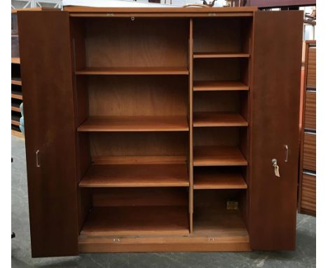 A mid century cupboard having two sets of bi-fold doors, opening to two separate shelf sections of respectively four and five