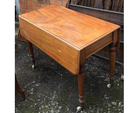 A light mahogany Pembroke table, on baluster turned legs and ceramic casters, 98x51x72cmH 