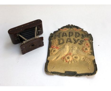 A Kodak bakelite no.2 Hawkette bellows camera; together with a pressed card 'Happy Days' wall hanging 