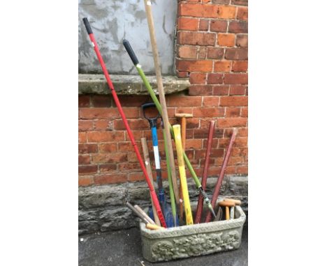 A good selection of garden tools in a composite stone planter, the planter 71cmL 