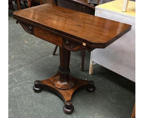 A Victorian rosewood swivel top card table, on tapering carved column and quatrefoil base, 91x45x76cmH 