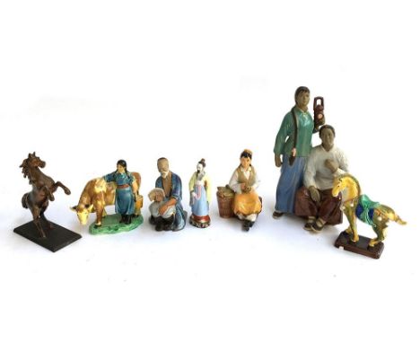 A number of Oriental ceramic figurines, the largest 29cmH, together with one cast metal horse, 17cmH 