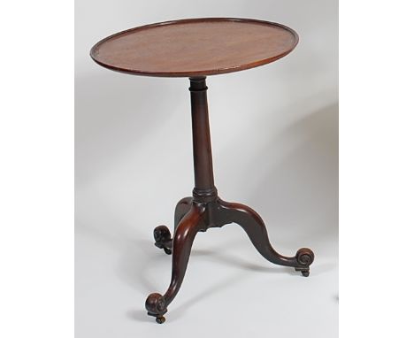 A George III mahogany pedestal tripod table, having circular fixed dish top (a/f) to gun barrel column, on hipped cabriole su