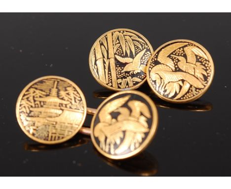 A pair of Japanese Meiji period Komai cufflinks, each in two-colour gold depicting leaves and birds on a black enamel ground,