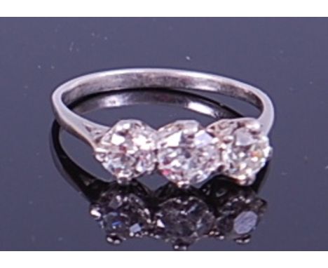 A platinum diamond three stone ring, arranged as three claw set old brilliants in a line setting, total diamond weight estima