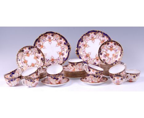 A Royal Crown Derby bone china twelve place setting tea-set, in the Imari palette, pattern No.5853, comprising teacups, sauce