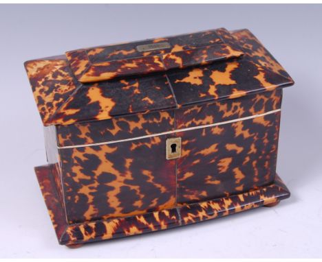 A Regency blond tortoiseshell and white metal inlaid tea caddy, of sarcophagus form, the hinged lid with initialled cartouche