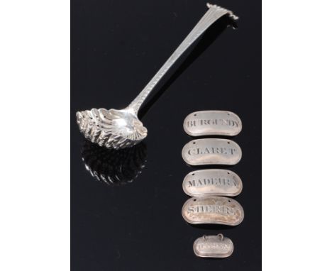 An early George III silver sifting spoon, having pierced shell shaped bowl to shell scroll terminal, maker probably William T