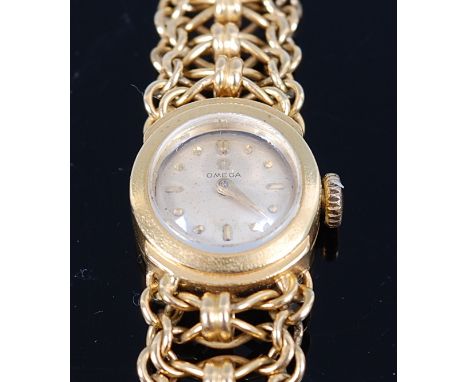 A ladies 18ct gold Omega bracelet watch, having a signed champagne dial with baton markers, seventeen jewel 480 movement, the