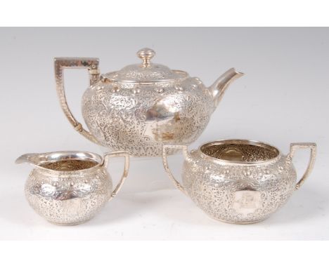 A Victorian silver bachelors three piece tea-set, comprising teapot, twin handled sugar and cream, each having vacant and eng