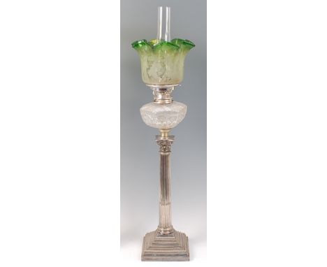 A silver plated Corinthian column pedestal oil lamp, having green tinted and acid etched shade, hobnail and diamond cut reser