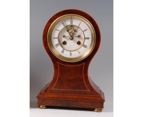 An Edwardian mahogany and inlaid balloon shaped mantel clock, having white enamel dial with Roman numerals, visible escapemen