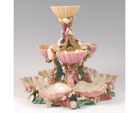 A Royal Worcester porcelain three-tier oyster stand, having scallop shell bowls, the supports encrusted with shells, the whol