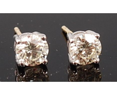 A pair of 18ct gold and diamond ear studs, the four claw set round brilliant cut diamonds each weighing approx 0.55ct, we wou