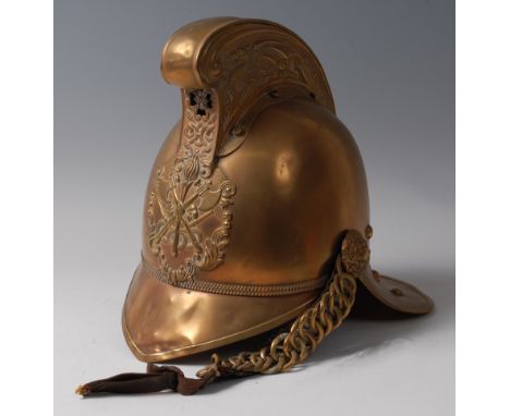 An early 20th century brass Merryweather fireman's helmet, the high comb with dragon decoration above an applied crossed axe 