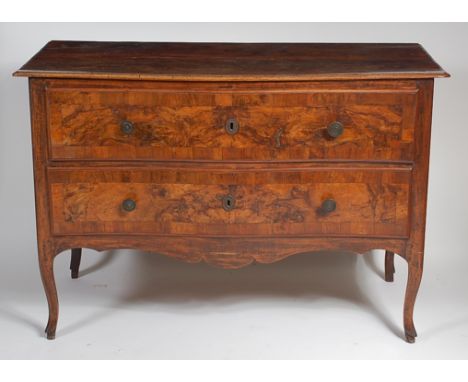 An 18th century French provincial walnut and figured walnut commode, of two long gentle serpentine crossbanded drawers, raise