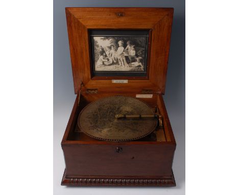 A late 19th century German walnut cased and polychrome painted symphonion, of casket form, the hinged lid opening to reveal l