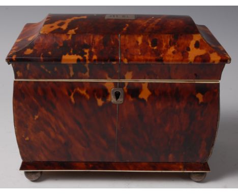 A Regency blond tortoiseshell, white metal and ivory mounted tea caddy, of sarcophagus form, the hinged lid with monogrammed 