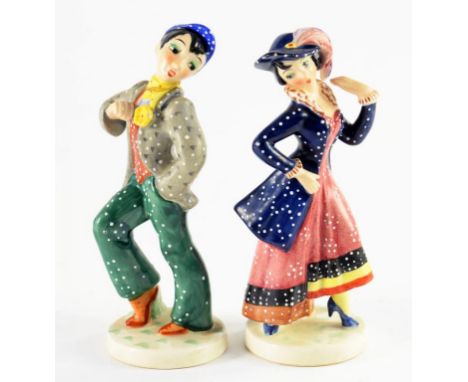 A PAIR OF GOEBEL FIGURINES, THE YOUNG GIRL WEARING A BLUE JACKET AND HAT AND THE MAN IN A BLUE CAP AND GREEN TROUSERS, 13CM H