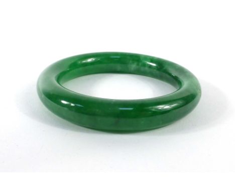 A dark green jade bangle, internal d. 5.8 cm