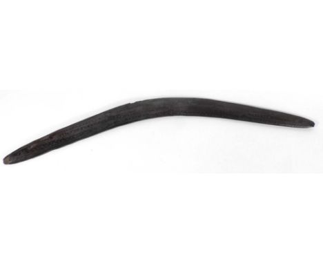 Tribal Art: an Australian Aboriginal boomerang, the face incised with linear decoration and crosses, presumably 19th century,