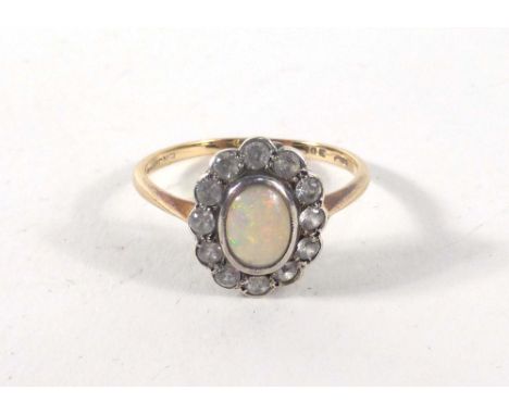 A 9ct yellow gold cluster ring set oval opal in a surround of twelve small diamonds,ring size P,2.1 gms