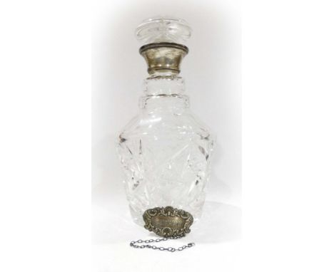 A silver mounted cut glass decanter, maker R&D, Birmingham 1977, h. 24 cm, suspending a silver 'Sherry' decanter label (2) CO