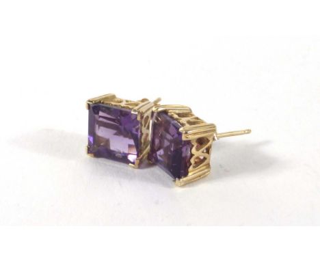 A pair of 9ct yellow gold ear studs, each set a single square cut amethyst within a pierced heart design setting, overall 2.9