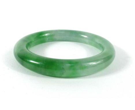 A green jade bangle, internal d. 5.7 cm