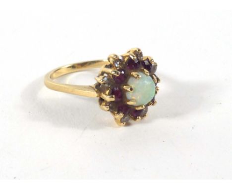 An 18ct yellow gold cluster ring set circular opal in a surround of small rubies and diamonds,ring size M 1/2,4 gms