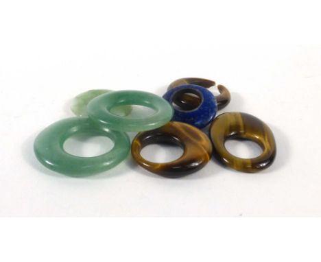 Three pale green jade pendants, three similar tiger's eye pendants and a lapis lazuli example (7) CONDITION REPORT: Some dama