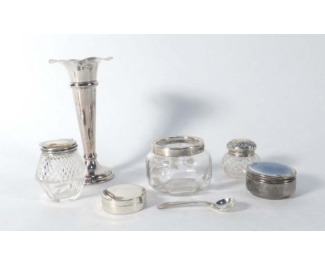 A mixed parcel of silver consisting a spill vase, two napkin rings, four silver mounted bottles, two pill containers and a bu