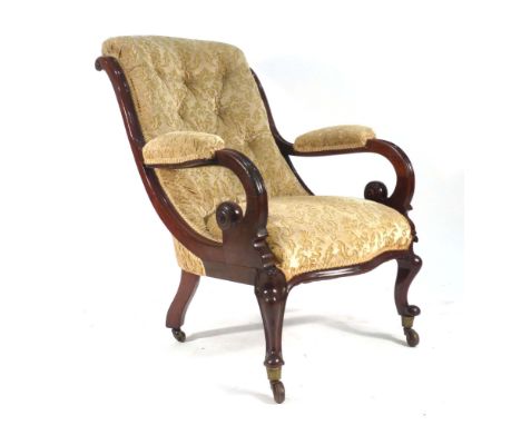 A 19th century mahogany and button upholstered open armchair on scrolled front legs with castors CONDITION REPORT: Wear comme