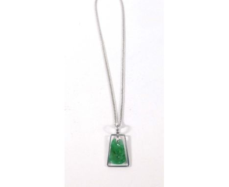 A platinum flat curblink necklace suspending an 18ct white gold pendant set carved jade, overall 9.2 gms