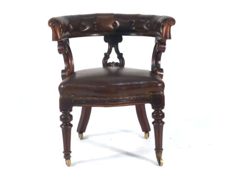 A Victorian mahogany, brown leather and button upholstered smoker's or elbow chair on turned legs with castors